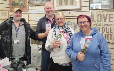 Small group of people holding flower posies.